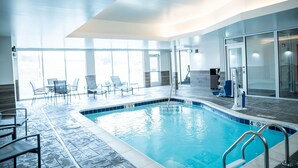 An indoor swimming pool with clear blue water, surrounded by lounge chairs and a glass wall. - Fairfield Inn & Suites by Marriott Kingsport (Kingsport)