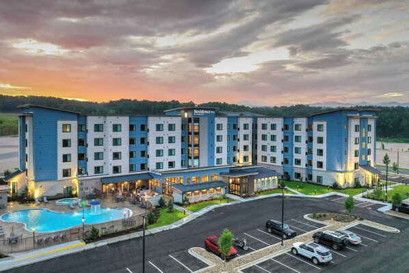 A hotel with a pool, multiple floors, and a well-lit entrance. - Residence Inn by Marriott Pigeon Forge (Pigeon Forge)