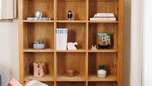 Une bibliothèque en bois agrémentée de divers objets décoratifs et de livres.
