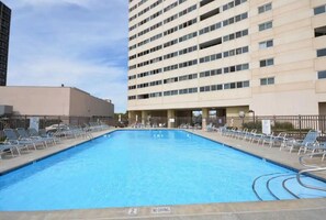 A swimming pool with lounge chairs and a 'No Diving' sign, surrounded by buildings. - Nothing Beats Oceanfront OCMD!! (Ocean City)