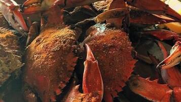 A large group of cooked crabs piled together.