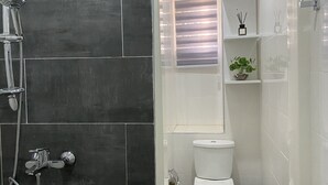 A bathroom with a shower, toilet, and sink. - Exotic 2 Bedrooms Apartment (Accra)