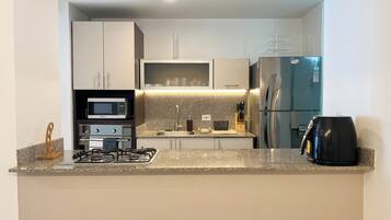 Microwave, oven, coffee/tea maker, cookware/dishes/utensils