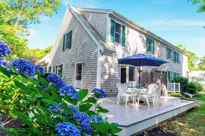 A two-story house with a covered patio area. - Short Walk to Private Beach! (West Yarmouth)