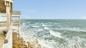 A wooden pier extending into the ocean with a clear view of the sea and a distant shoreline. - Waterfront...Breathtaking View...Great Fishing...Beautiful Home!!! (Freeport)