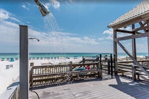 Une terrasse au bord de la plage offrant une vue sur l’océan et la plage.