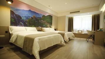 A hotel room with two beds, a desk, a chair, and a large mural on the wall.