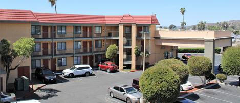 A multi-story parking garage with several cars parked.