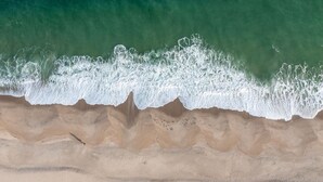 A beach with waves crashing onto the shore. - Stunning Point Pleasant Beach 6BR 5Bath Ocean Front Home - Heated Inground Pool (Point Pleasant Beach)