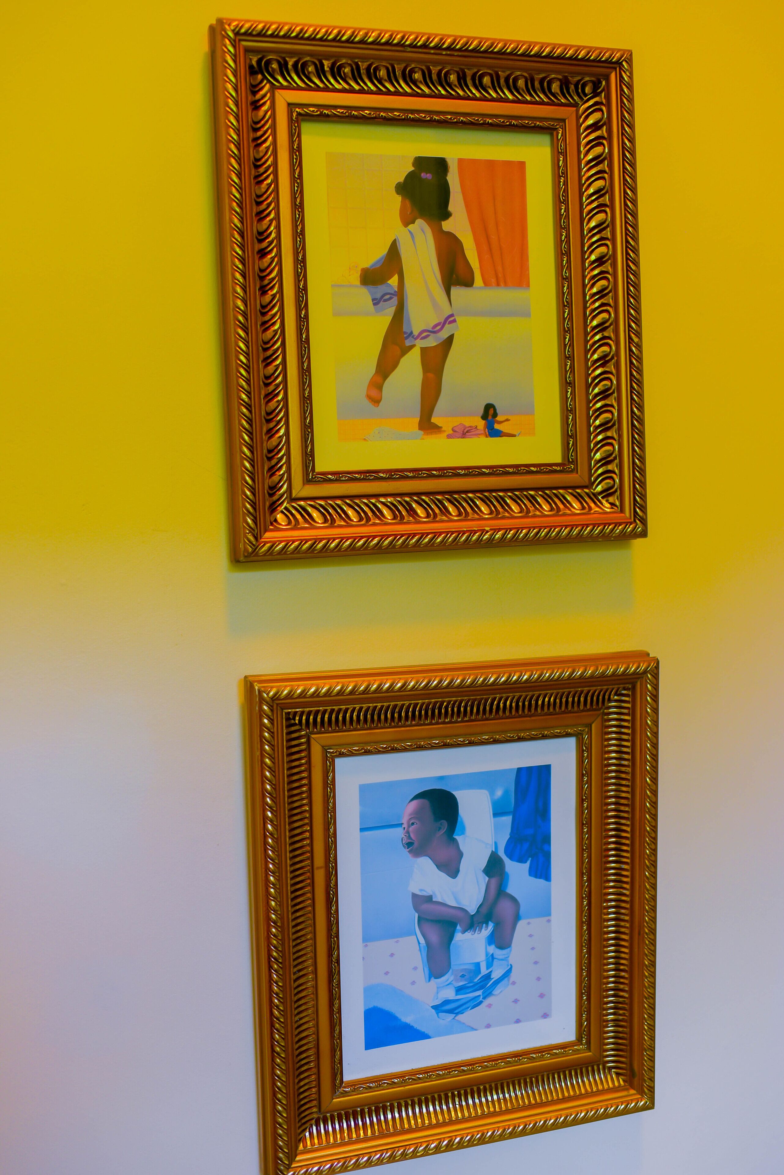 Two framed artworks on a wall.