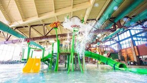 An indoor water park with multiple water slides and a large open space. - $0Fees-6bed/6bath-Easy Red Rocks/Downtown/OldeTown (Arvada)