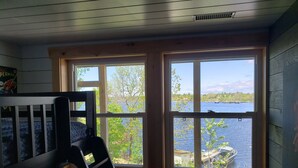 A room with a view of a lake, a bunk bed, and wooden walls. - Fabulous New Georgian Bay Cottage on the  water! (Byng Inlet)