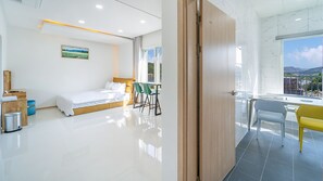 A modern hotel room with a bed, a desk, and a view of the outdoors. - Gapyeong Boreum-dal Poolvilla (Gapyeong)