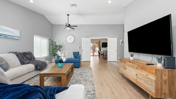 A modern living room with a sofa, coffee table, and TV stand. - Gorgeous House with POOL!! (Elk Grove)