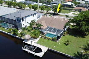 A heated pool - Luxury Gulf Access Retreat | Outdoor Kitchen, Heated Pool, Hot Tub, Tiki Bar & Waterfront Dock (Cape Coral)