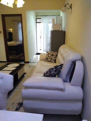Deluxe Apartment | Living area | 14-inch Smart TV with digital channels, TV - Stay.Plus Hurlingham Business Apartment (Nairobi)