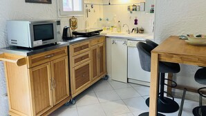 A compact kitchen with a microwave, toaster, and sink. - Villa Irène by Interhome (Bravone)