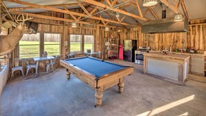 A rustic wooden interior with a pool table, chairs, and a deer head decoration. - Bright ‘Green Gables’ Cabin: Hike, Swim & BBQ (Lewisburg)