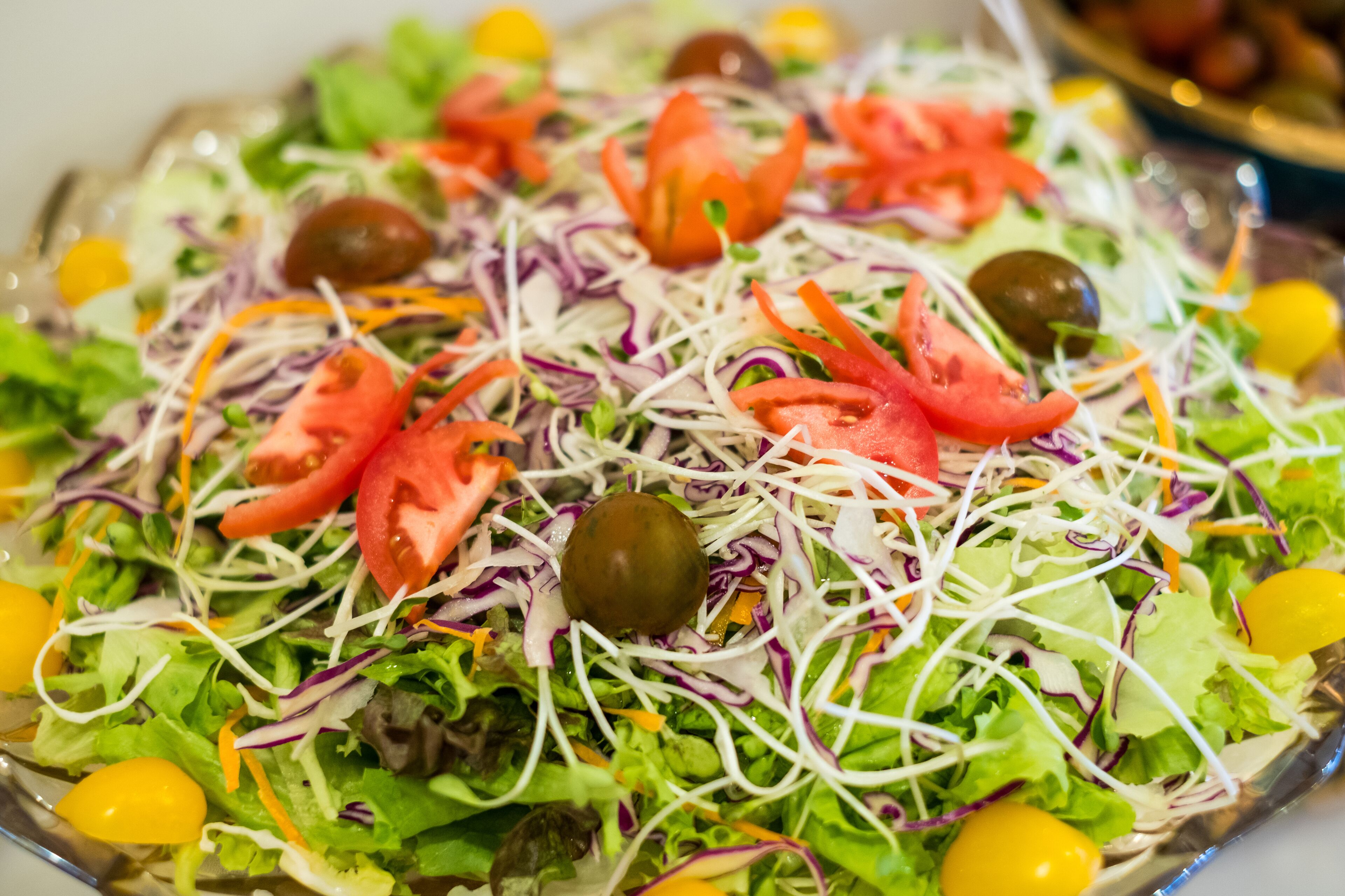 A salad with various vegetables and olives.
