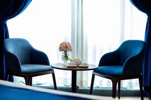 Luxury Double Room | Living area | 25-inch LCD TV with cable channels, TV, printers
