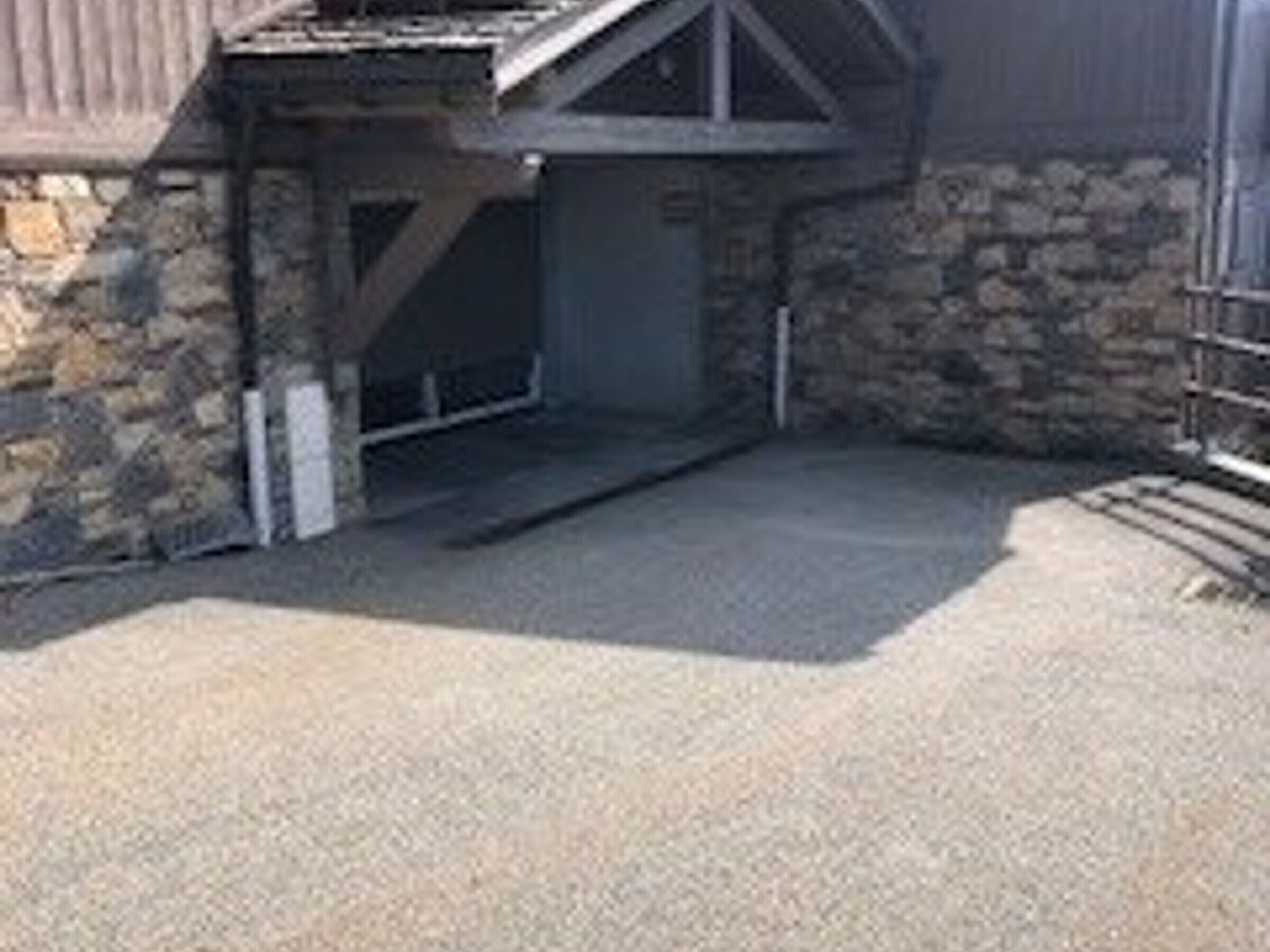 Een gebouw met een stenen gevel en een metalen deur.