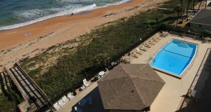 Sunset and river view condo with a large balcony and heated beachfront pool