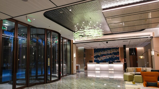 A modern lobby with a marble floor, a reception desk, and seating areas. - Holiday Inn Express Tianjin Binhai by IHG (Tianjin)