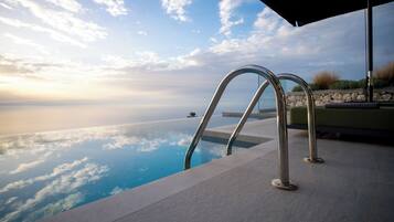Une piscine offrant une vue dégagée sur l’océan et le ciel.