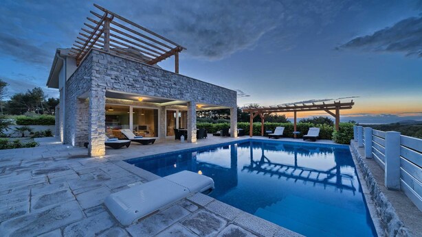 A stone villa with a swimming pool, outdoor seating, and a pergola. - Villa Luxoria - for 10 guests with 4 bedrooms, a private pool and a spa by MyWaycation (Jelsa)
