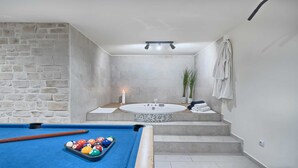 A modern bathroom with a bathtub, a shower, and a pool table. - Villa Luxoria - for 10 guests with 4 bedrooms, a private pool and a spa by MyWaycation (Jelsa)