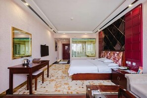 A hotel room with a bed, a desk, a chair, a TV, and a wardrobe. - Pangye Hotel (Dayao)