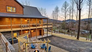 A log cabin with a deck, outdoor seating, and a fire pit. - StepstoGSM*Bigdogfrndly*Pool*Minigolf (Wear Valley)