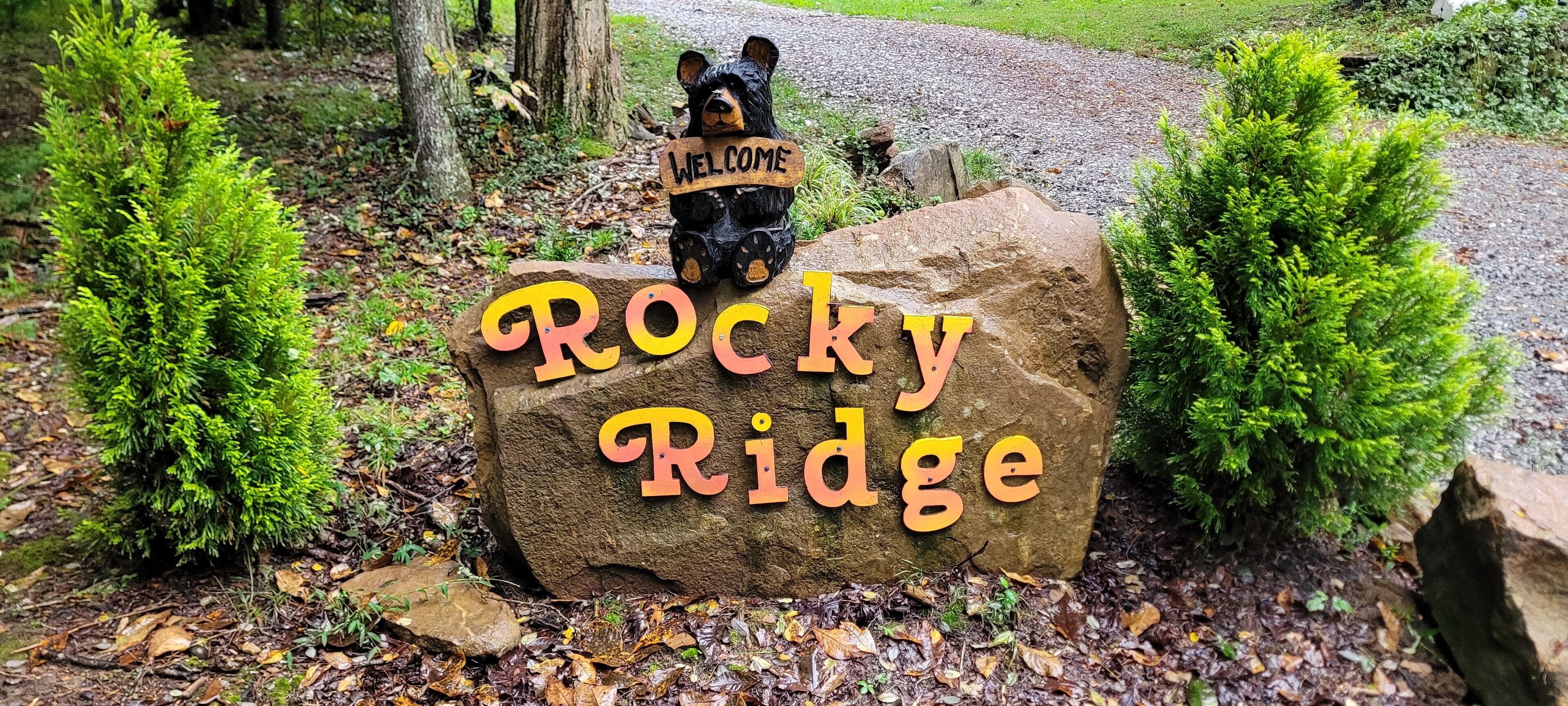 A welcome sign with a bear figure at Rocky Ridge.