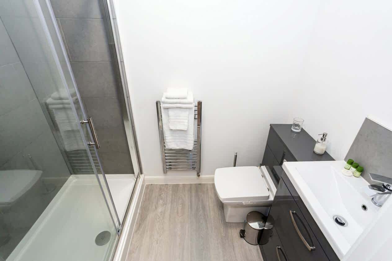 Shower, hair dryer, towels, shampoo
