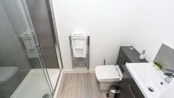 Shower, hair dryer, towels, shampoo