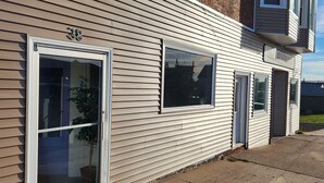 A two-story building with a brick facade and white siding.