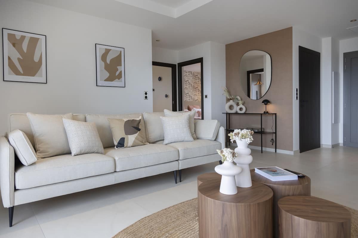 A modern living room with a sofa, coffee table, and decorative items.