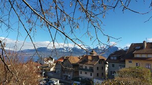 A residential area with houses, a clear sky, and mountains in the background.