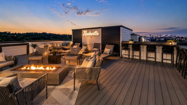 A rooftop deck with outdoor seating, a fire feature, and a neon sign reading 'Nashville.' - Rooftop Skyline Views DT Nash Sleeps 12 (Nashville)