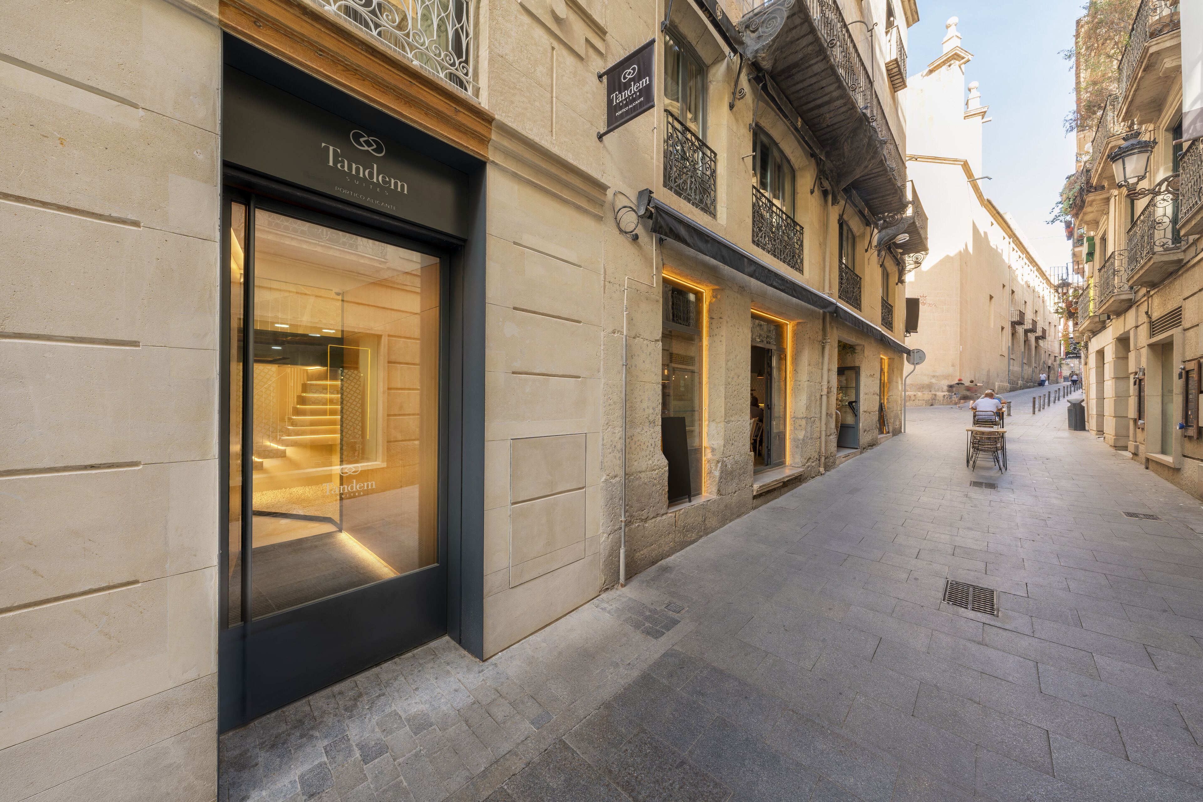 A street view of a building with a storefront labeled "Tandem."