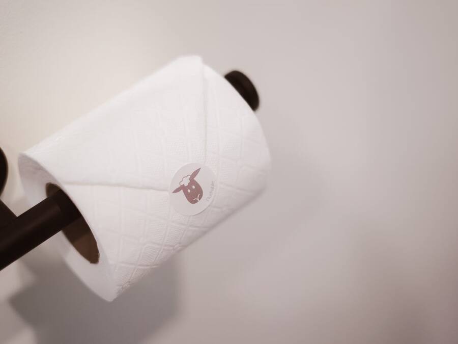 A roll of toilet paper with a logo on it.