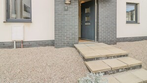 A modern building with a dark blue door, a small set of steps leading to the entrance, and a light-colored exterior. - 10 Goodhope Gardens (Aberdeen)