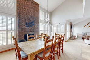 Cozy living area with a fireplace, dining table, and comfortable seating.