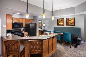 Enjoy cooking in this well-equipped kitchen with a central island, oven, and microwave.