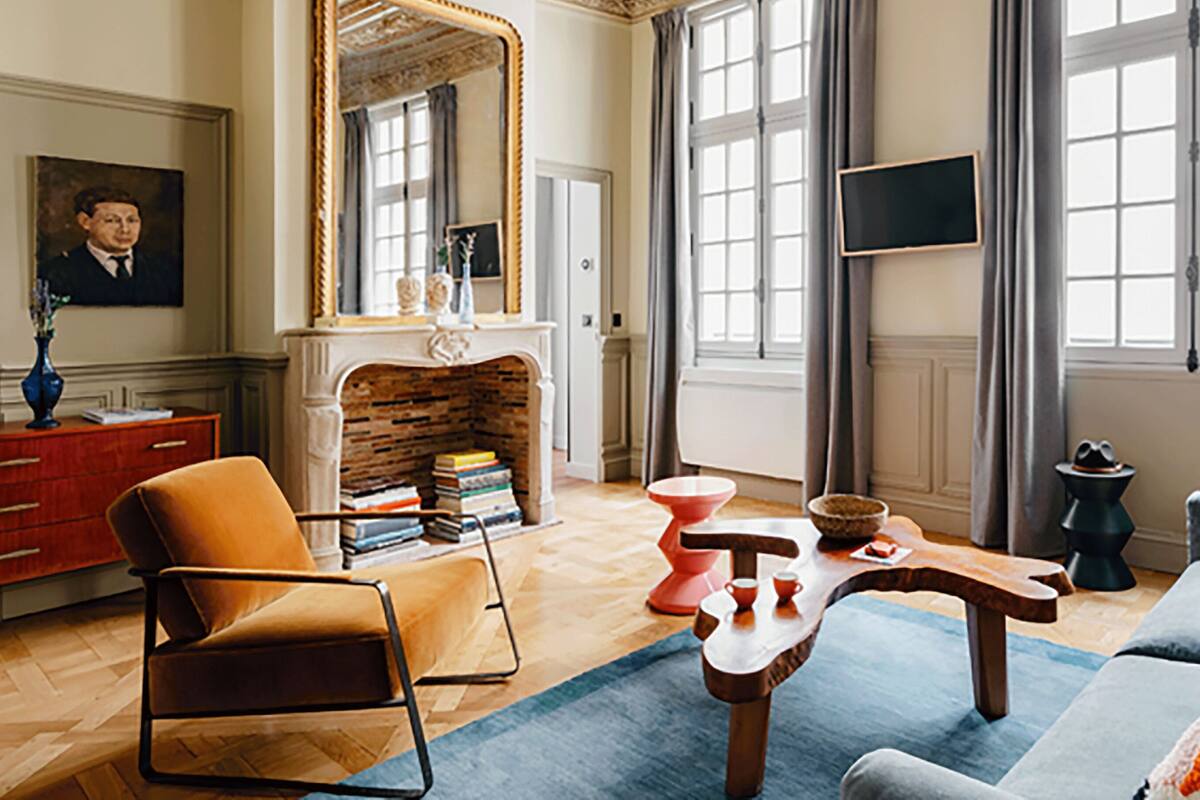 A living room with a fireplace, a sofa, a coffee table, and a television.