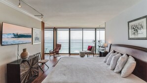 A spacious bedroom with a large bed, a view of the ocean, and modern decor. - Capri by the Sea 905 | Ocean View | Full Kitchen | Private Bedroom | Beach Access | On the Boardwalk (San Diego)