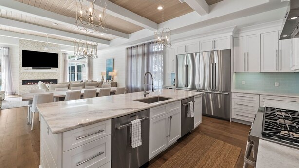 A modern kitchen with a large island, stainless steel appliances, and a fireplace. - Casa al Mare|Easy Beach Access|Private Pool|Golf Cart (Seagrove)