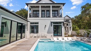 A two-story house with a swimming pool, large windows, and a balcony. - Casa al Mare|Easy Beach Access|Private Pool|Golf Cart (Seagrove)