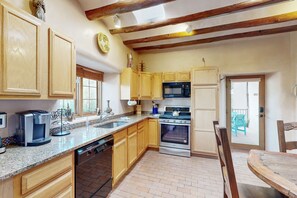 Enjoy cooking in this well-equipped kitchen with oven, microwave, and dishwasher.
