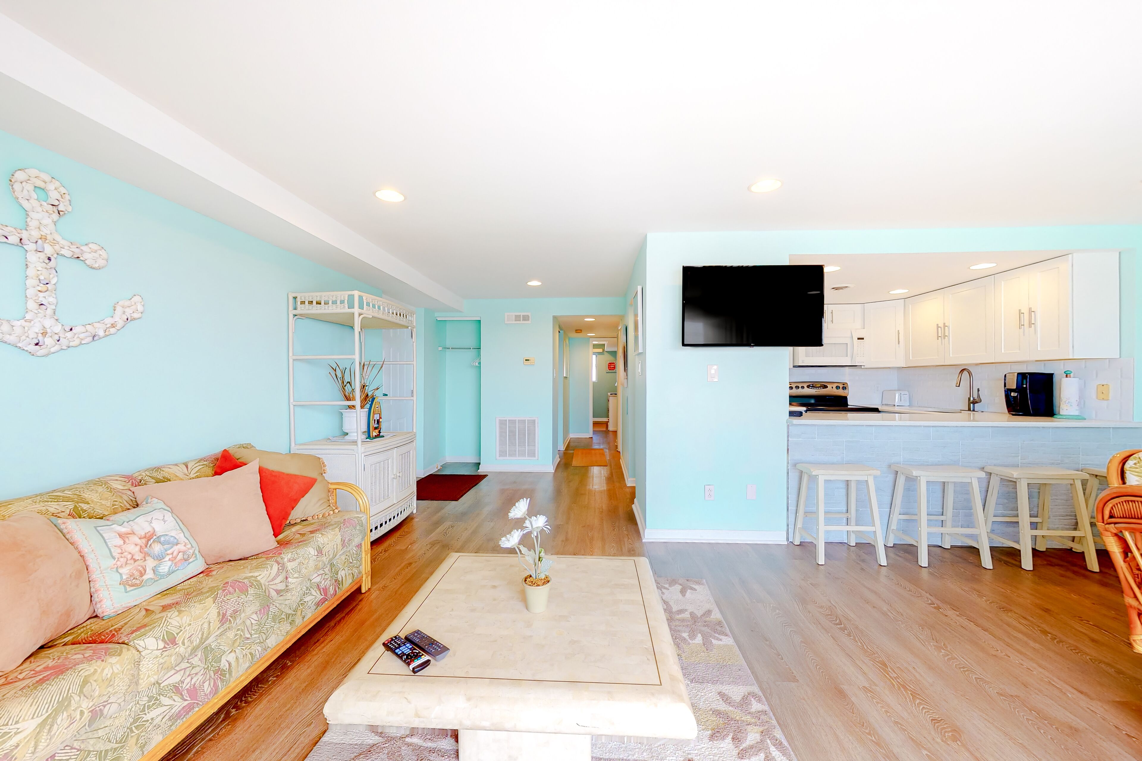 Updated, third-floor condo with balcony, W/D, central AC, & WiFi - near beach